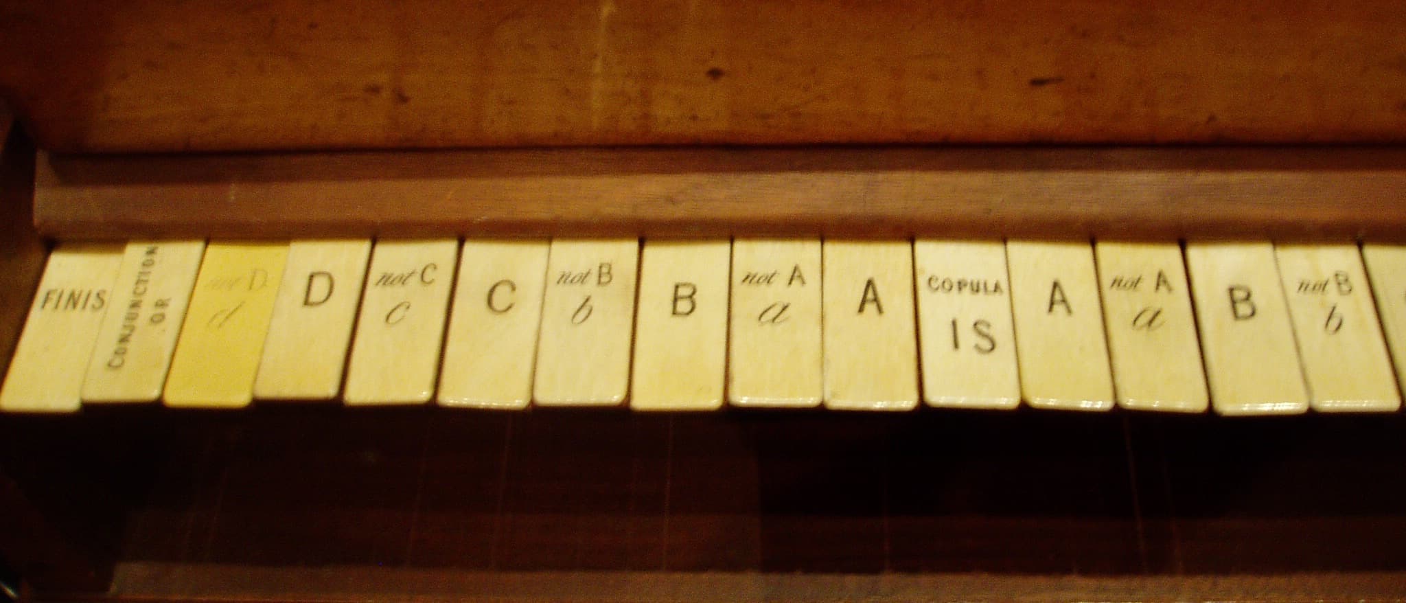 Ivory keys of the logic piano built for William Stanley Jevons, labelled with letters, their negations, COPULA IS, CONJUNCTION OR and FINIS