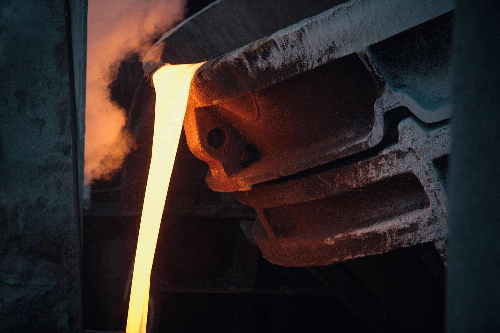 Molten metal pouring from a foundry ladle