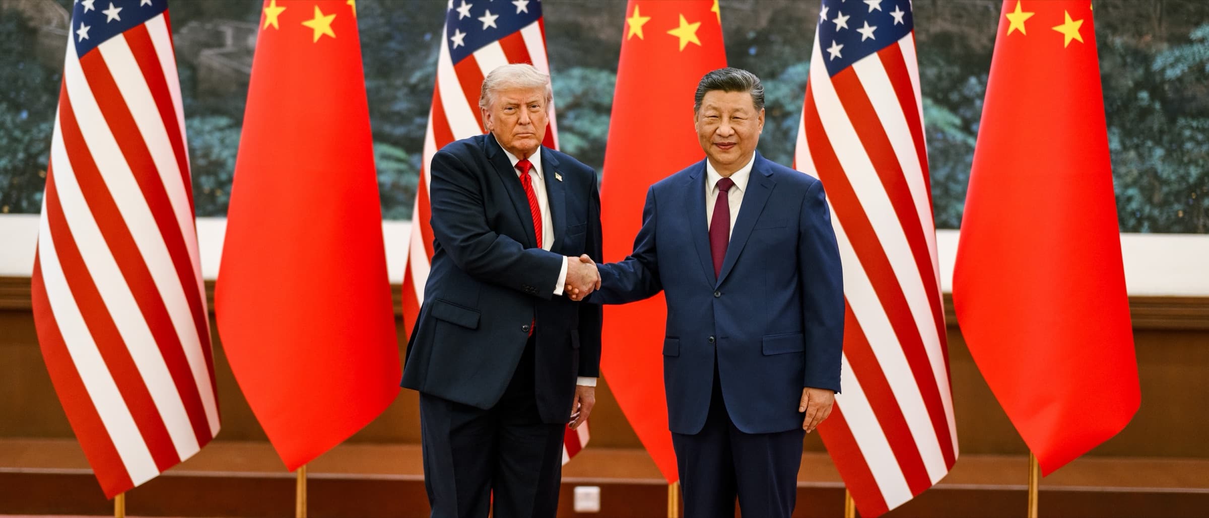 Donald Trump and Xi Jinping shake hands in front of US and Chinese flags at the welcome ceremony in the Great Hall of the People, Beijing, 14 May 2026
